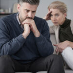 When Love Feels Heavy: Navigating Difficult Seasons Together Worried,Husband,And,Wife,Sitting,In,Marriage,Therapy,With,Focus