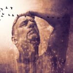 Man,With,Eyes,Closed,And,Hand,On,Head,,Expressing,Introspection,