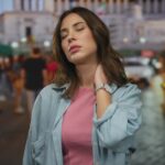Woman,In,Pink,Shirt,And,Denim,Jacket,Stands,In,Busy