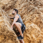 Young,Brunette,Man,Climbing,Natural,Rocky,Wall