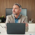 Thinking,,Man,And,Research,With,Laptop,,Office,And,Decision,For
